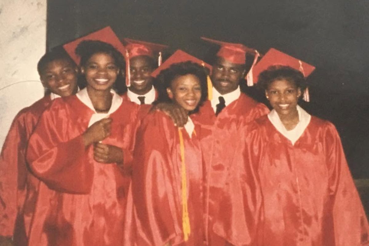 Six J.W. Sexton Class of 1986 graduates in red caps and gowns on graduation day