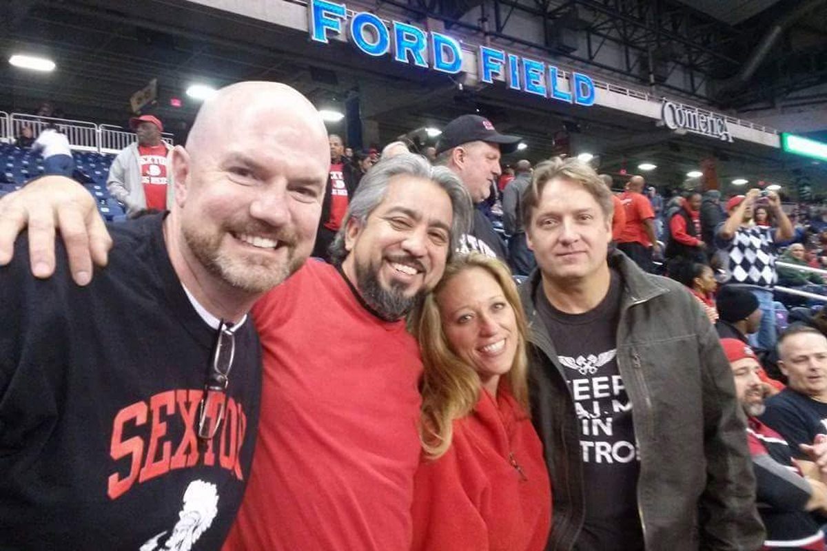 Classmates wearing Sexton Big Reds gear together at a Detroit Lions game at Ford Field