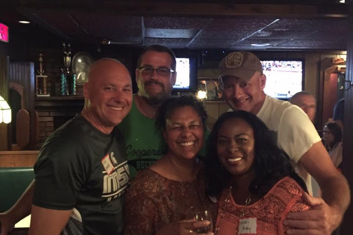 Classmates gathered together at a reunion get-together